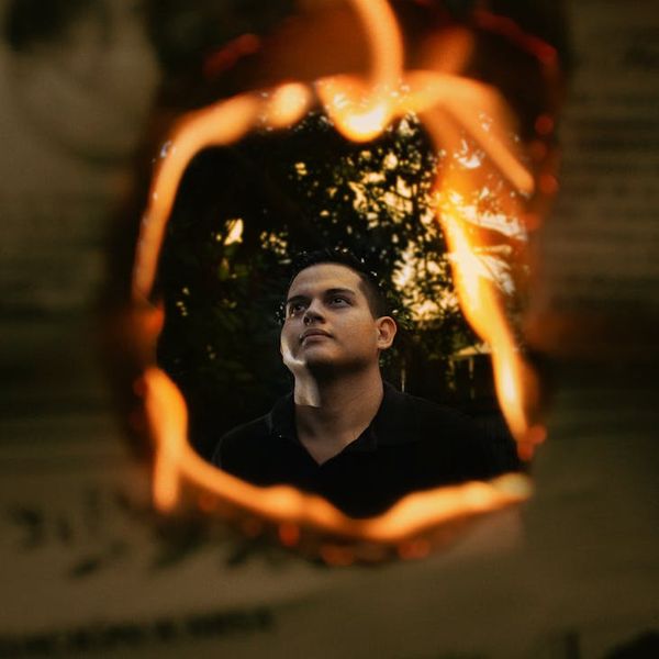 Silhouette of a man stretching against a backdrop suggesting energy and focus.